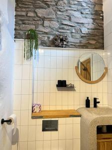a bathroom with a sink and a mirror at Little Hillside in Porthtowan