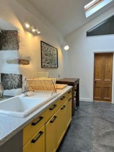 a kitchen with a sink and a counter top at Little Hillside in Porthtowan