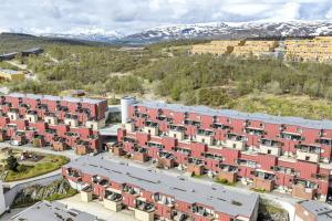 an aerial view of an apartment complex with red buildings at Flott og sentral moderne leilighet på 2 etasjer in Tromsø