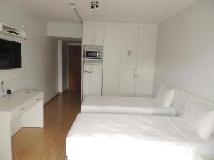 Tempat tidur dalam kamar di Brasilia Apart Hotéis