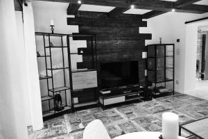 a living room with a television and a fireplace at APARTMAN Tradicia in Michalovce