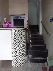 a stairway with a laptop on top of a counter at Hostel Arena Prime in Salvador