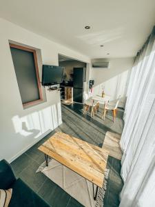 a living room with a table and a dining room at BEACH HOUSE 100M PLAGE, SUR LE PORT. in Frontignan