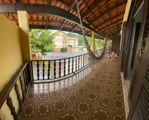 an indoor balcony with a tile floor and a railing at Pousada Estrela Dalva in Penha
