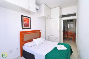 1 dormitorio pequeño con 1 cama y cocina en Belo 2 quartos para 6 pessoas na quadra da praia, en Río de Janeiro