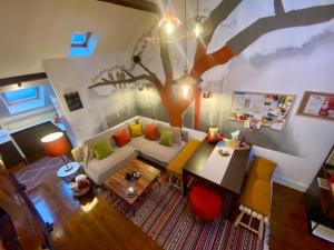 an overhead view of a living room with a tree on the wall at Studios with Mezzanine Rua da Moeda in Lisbon