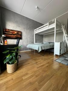 a bedroom with a bed and a loft bed at Modern apartment near Helsinki airport in Vantaa