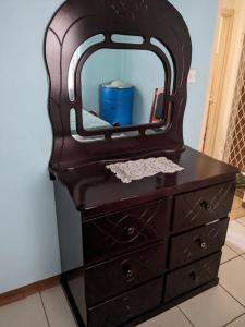 a wooden dresser with a mirror on top of it at Bed and breakfast in Georgetown