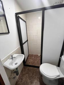 a bathroom with a shower and a toilet and a sink at 7 Express in Medellín