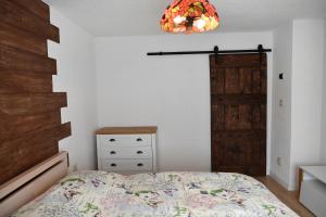 a bedroom with a bed and a wooden door at APARTMAN Tradicia in Michalovce +23 photos