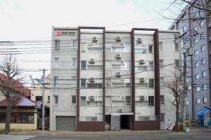 a tall building with windows in front of it at Liberte Nakajima Park Room 201,302 - Vacation STAY 98202v in Sapporo