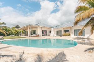 an image of a villa with a swimming pool at 4BR Villa w private pool at Lagunas Cap Cana in Punta Cana