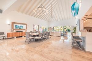 a dining room and living room with a table and chairs at 4BR Villa w private pool at Lagunas Cap Cana in Punta Cana