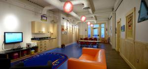 a kindergarten classroom with orange chairs and a television at White Point Beach Resort in Summerville Centre