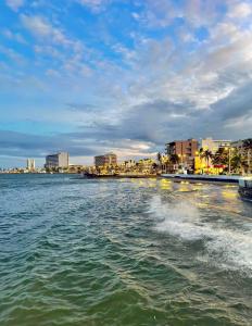 a body of water with a city in the background at Suites Brisa Marina - Playa Regatas y Malecón in Veracruz