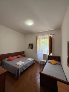 - une chambre avec deux lits, une chaise et une fenêtre dans l'établissement VILLA LUCIA, à Matino