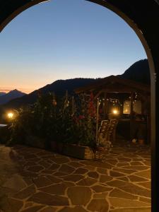 a view from an archway of a patio at night at Bergwald in Alpbach