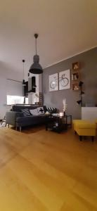 a large living room with a bed and a table at Apartament DANI in Nysa