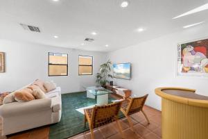 a living room with a couch and a table at La Quinta Casita : Private Pool - Close to Old Town in La Quinta