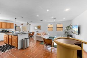 a kitchen and living room with a couch and a table at La Quinta Casita : Private Pool - Close to Old Town in La Quinta