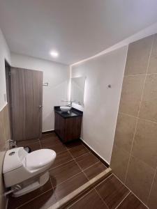 a bathroom with a toilet and a sink at 7 Express in Medellín