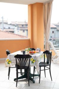 a table with chairs and fruit on a balcony at Terrazza baciata dal sole in Lazise