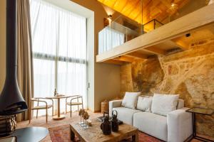 a living room with a couch and a table at Dajas Douro Valley - Exclusive Villas in Sande