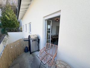 a patio with a bench and a trash can at 8 Personen I BBQ I Sunset in Herrsching am Ammersee