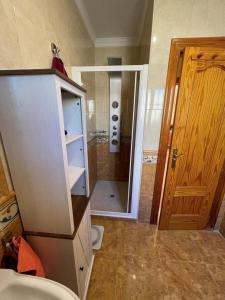 a bathroom with a shower and a toilet and a door at Llanos del Peral - Zurgena - sleeps 6 - R092 in Zurgena