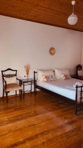 a bedroom with a bed and a chair and a table at Viktora’s house in Himare