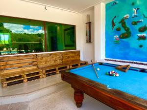 a pool table in a room with a large aquarium at Hotel Galapagos Tortuga Bay in Puerto Ayora