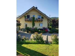 a house with a garden in front of it at Holiday apartment in the rose garden in Birach