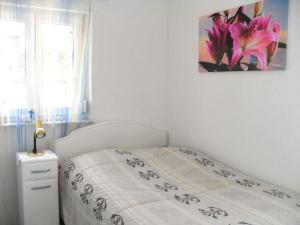a bedroom with a bed with a flower picture on the wall at Villa Lake Constance view in Stetten