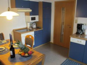 a kitchen with a table with a bowl of fruit on it at Bohn - Apartment 2 in Gersfeld