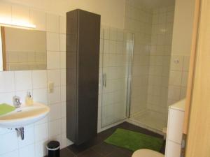 a bathroom with a shower and a sink at Holiday apartment Rursee in Simmerath +11 photos