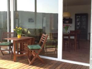 a patio with a table and chairs and a dining room at Holiday apartment Rursee in Simmerath