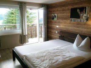 a bedroom with a large bed and a window at Holiday home Eckstein in Oy-Mittelberg