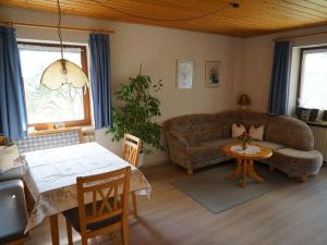 a living room with a couch and a table at Holiday apartment Hildegard birds in Oberreute
