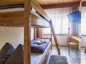 a bedroom with two bunk beds and a desk at Mensfelder Kopf near Limburg Lahn in Hünfelden