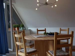a dining room with a table with chairs and a dining room at Holiday apartment holidays in the forest in Weisenbach
