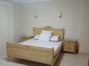 a bedroom with a bed with two night stands at بورتو مارينا الساحل الشمالي in El Alamein