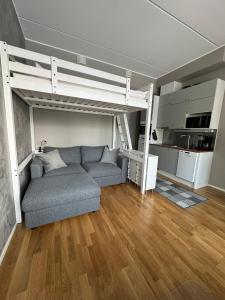 a living room with a couch and a loft bed at Modern apartment near Helsinki airport in Vantaa