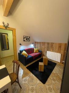 a living room with a couch and a table at REFUGE DU CAP in Saint-Lary-Soulan