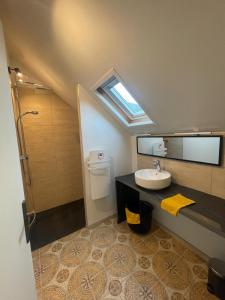 La salle de bains est pourvue d'un lavabo et de toilettes avec une lucarne. dans l'établissement REFUGE DU CAP, à Saint-Lary-Soulan