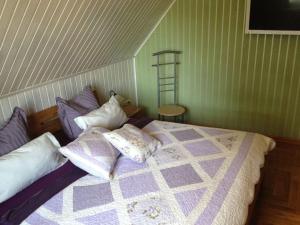 a bedroom with a bed with pillows on it at Holiday home Baltic Sea Dream in Zudar