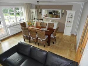 a living room with a table and a couch at Holiday home Baltic Sea Dream in Zudar