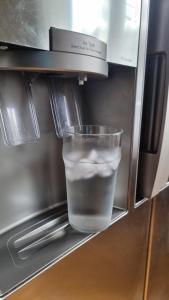 a cup of water is in a refrigerator at Trevlig lägenhet nära Strömstad centrum in Strömstad
