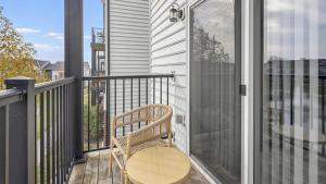 a balcony with a wooden chair and a table at Landing - Modern Apartment with Amazing Amenities (ID1218X266) in Dublin