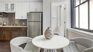 a kitchen with a table and chairs and a refrigerator at Landing - Modern Apartment with Amazing Amenities (ID7691X05) in Richmond