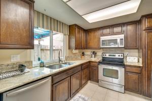 a kitchen with wooden cabinets and a stove top oven at Sun-Kissed Orangevale Home with Private Hot Tub! in Orangevale